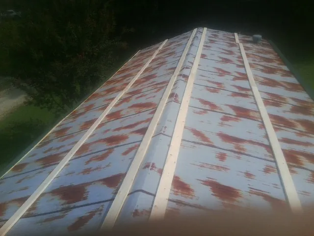 Rusted metal roof panels with new wood purlins before replacement — Storm Damage Roof Repair in Wayne by Roofing Brothers